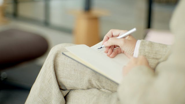 A woman writing in her notebook
