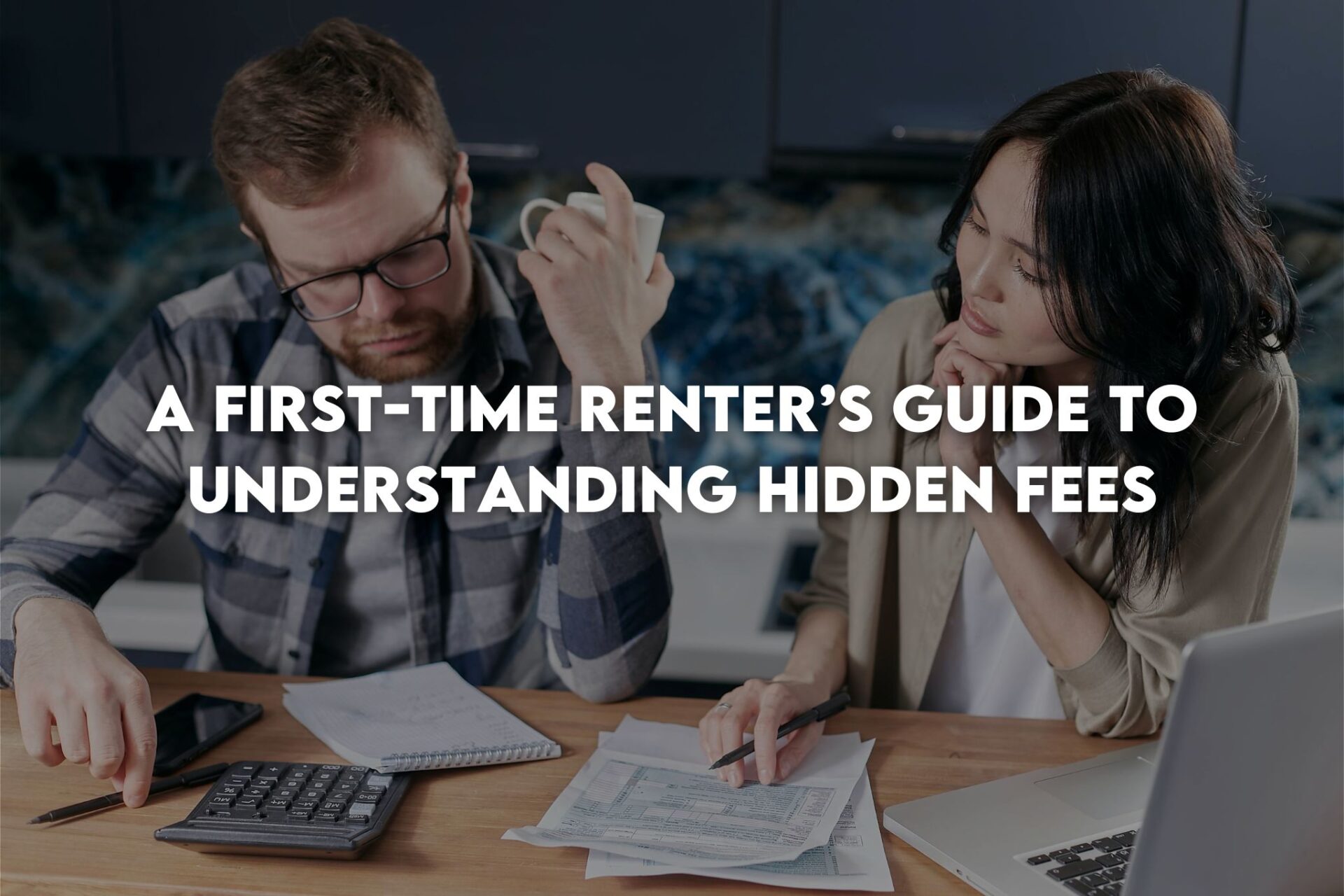 Couple looking at bills next to laptop and calculator