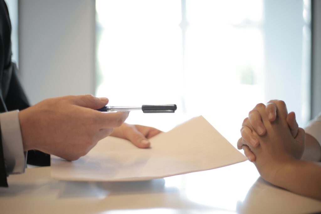 A Businessman giving a contract and a pen to a client